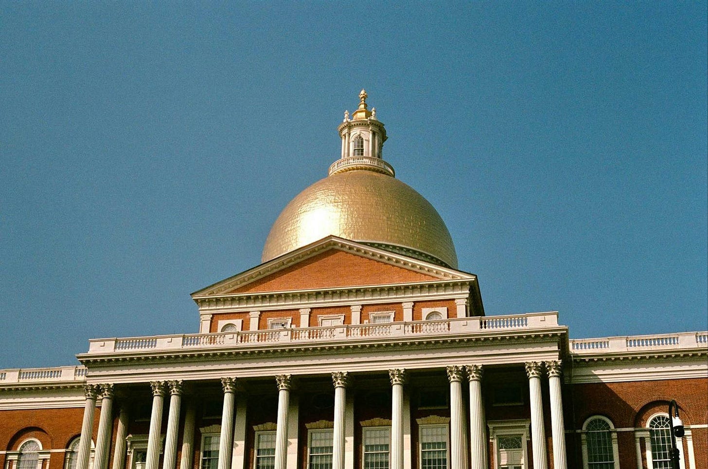 A large building with columns and a gold dome