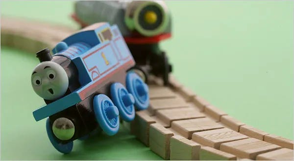 toy locomotive falling off the tracks toy locomotive falling off the tracks
