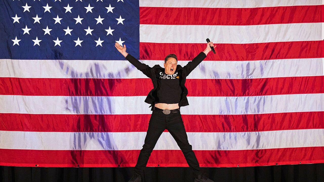 Elon Musk jumps on stage as he arrives to speak at a town hall event in support of  Donald Trump at the Greater Philadelphia Expo Center in Oaks, Pennsylvania, United States on October 18th 2024