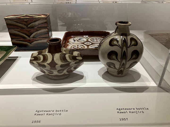 installation photographs of rounded ceramic vessels with multicolored abstract patterns