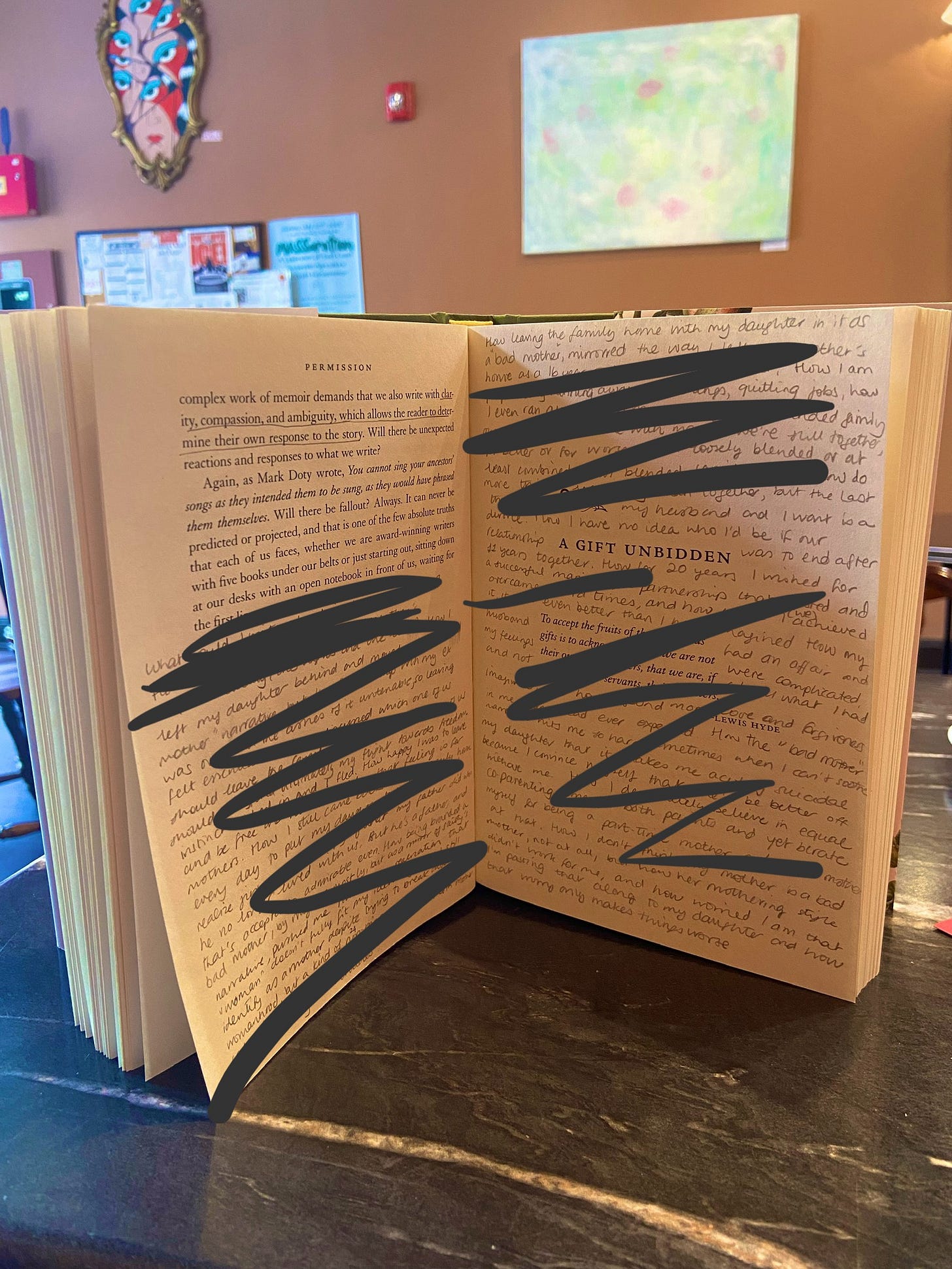 Photo of the book Permission standing open on a table in a cafe. Fragments handwritten in pencil read "left my daughter behind", "how I'm worried that I'm passing that along to my daughter and how that worry only makes things worse"