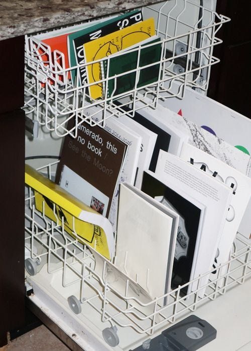 This may contain: there are many books in the dishwasher