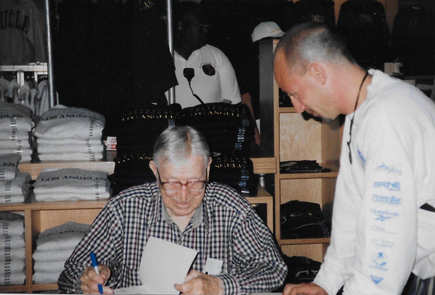 John Wooden signing his book