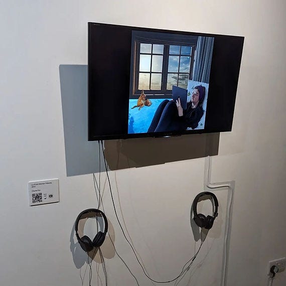A photo of a moving image artwork being exhibited on a tv in a gallery exhibition.