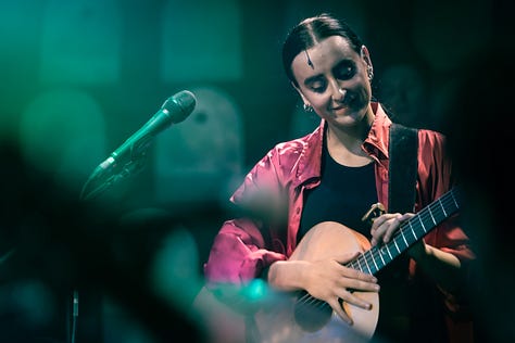 A series of images from Manic Street Creature, where Maimuna plays guitar on stage