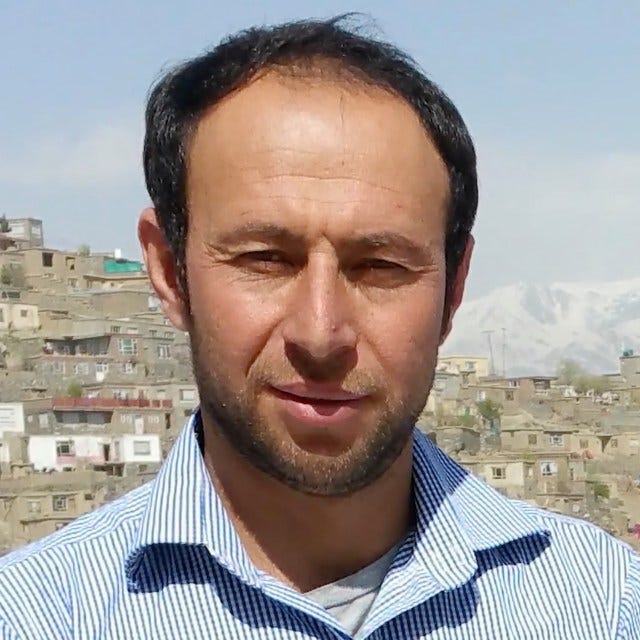 Picture of a man, late 30s or early 40s, against the backdrop of Kabul