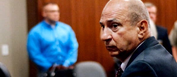 Pete Skandalakis looks over his shoulder off camera.