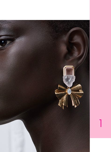 Women wearing crystal jewelry with pink accents. 