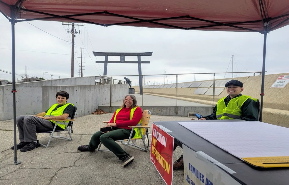 A group of people sitting in chairs under a red awning

AI-generated content may be incorrect.