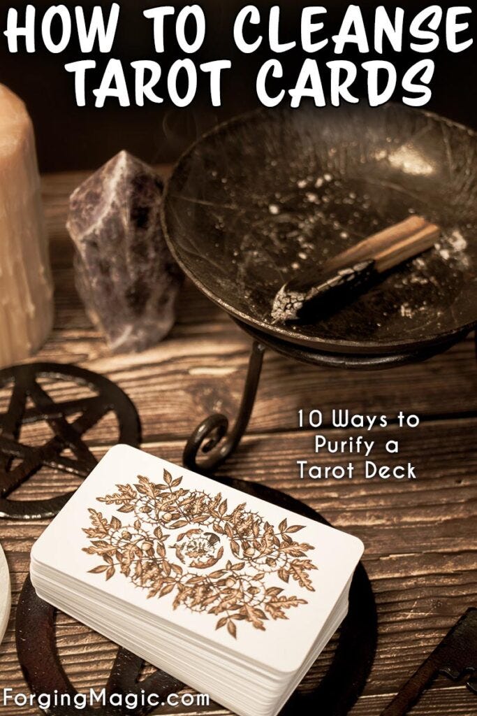 How to cleanse a tarot deck picture shows an altar with tarot cards, pentacles, candles, iron cauldron, crystals.