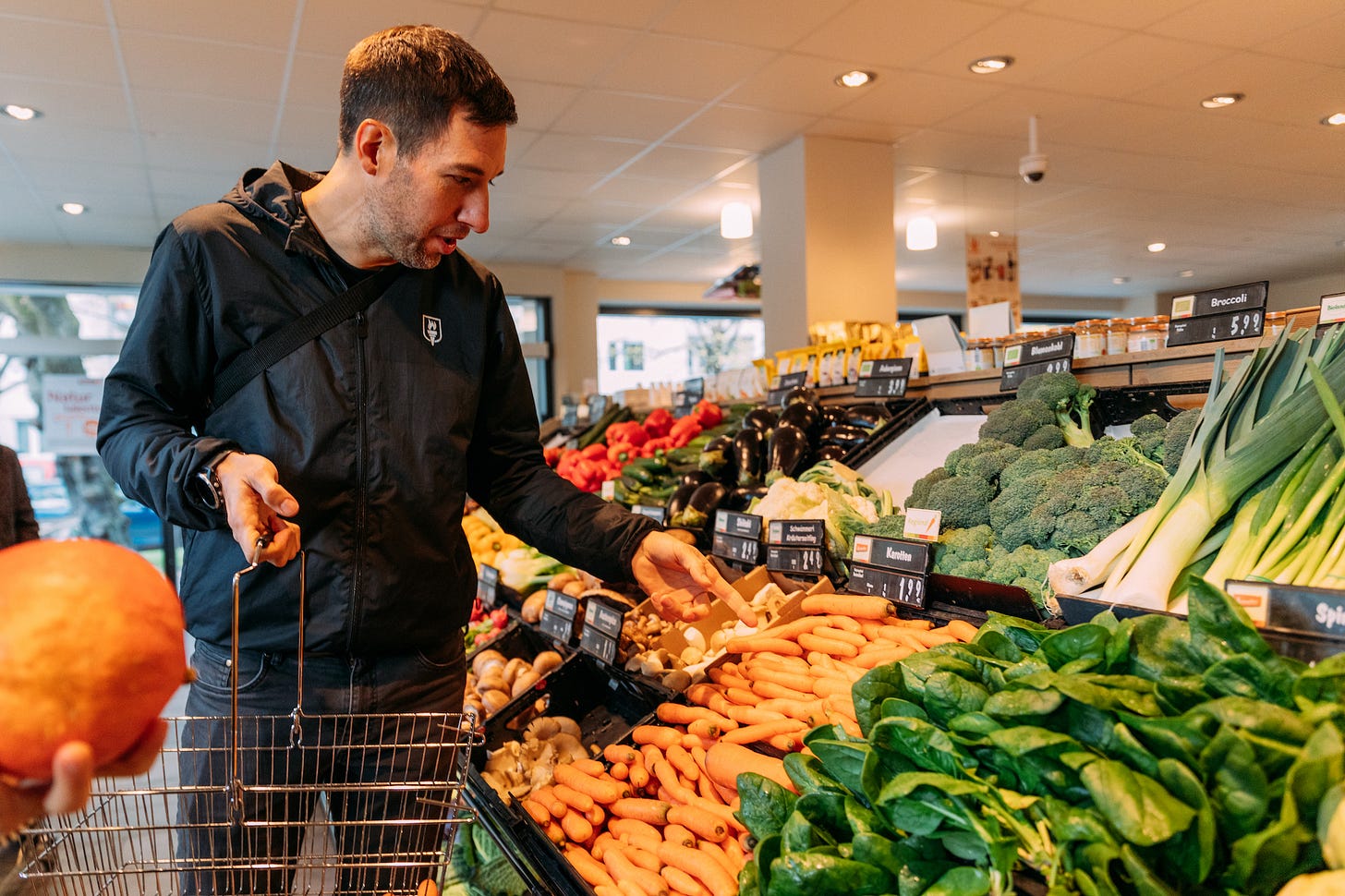 The author shopping fruit and legumes at the local health food store