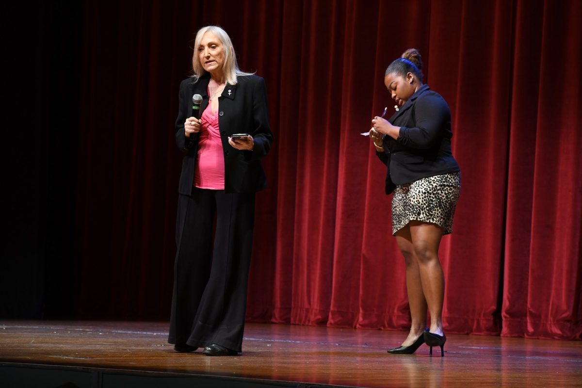 Francesca Bishop, El Camino College communication studies professor and forensics team director (left), describes how an impromptu speech is delivered after giving Associated Students Organization President Zaynah Robb three quotes to base a five-minute impromptu speech on, which she prepared on stage in two minutes during the Speaker's Forum at the Marsee Auditorium on Tuesday, Nov. 18. (Nikki Yunker | The Union)
