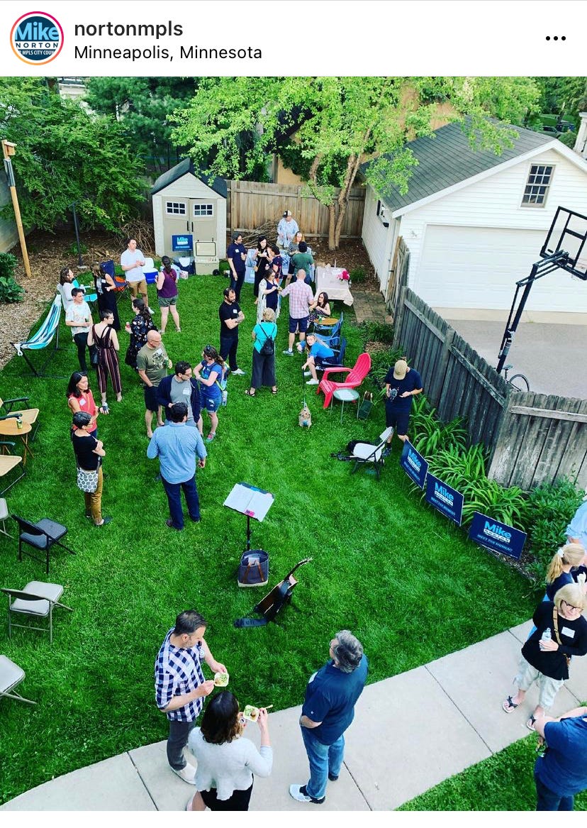neighbors gathered in a back yard, surrounded by Mike Norton for Minneapolis Council yard signs neighbors gathered in a back yard, surrounded by Mike Norton for Minneapolis Council yard signs
