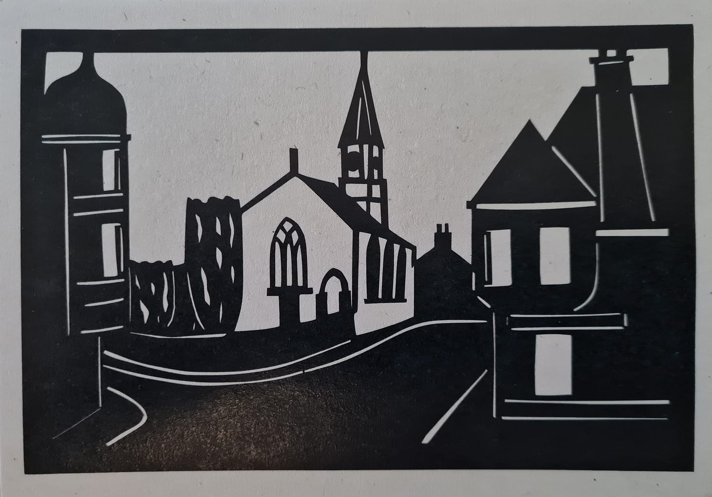 Paper cut postcard by Louise McLaren  which shows a scene of the church and the Mackintosh building in Comrie, Perthshire.
