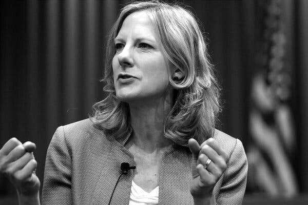 Heather Gerken, with a microphone on her lapel, gestures as she speaks to an audience. 