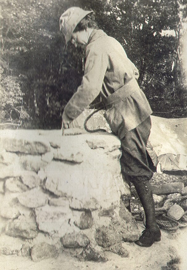 Woman drawing water from well