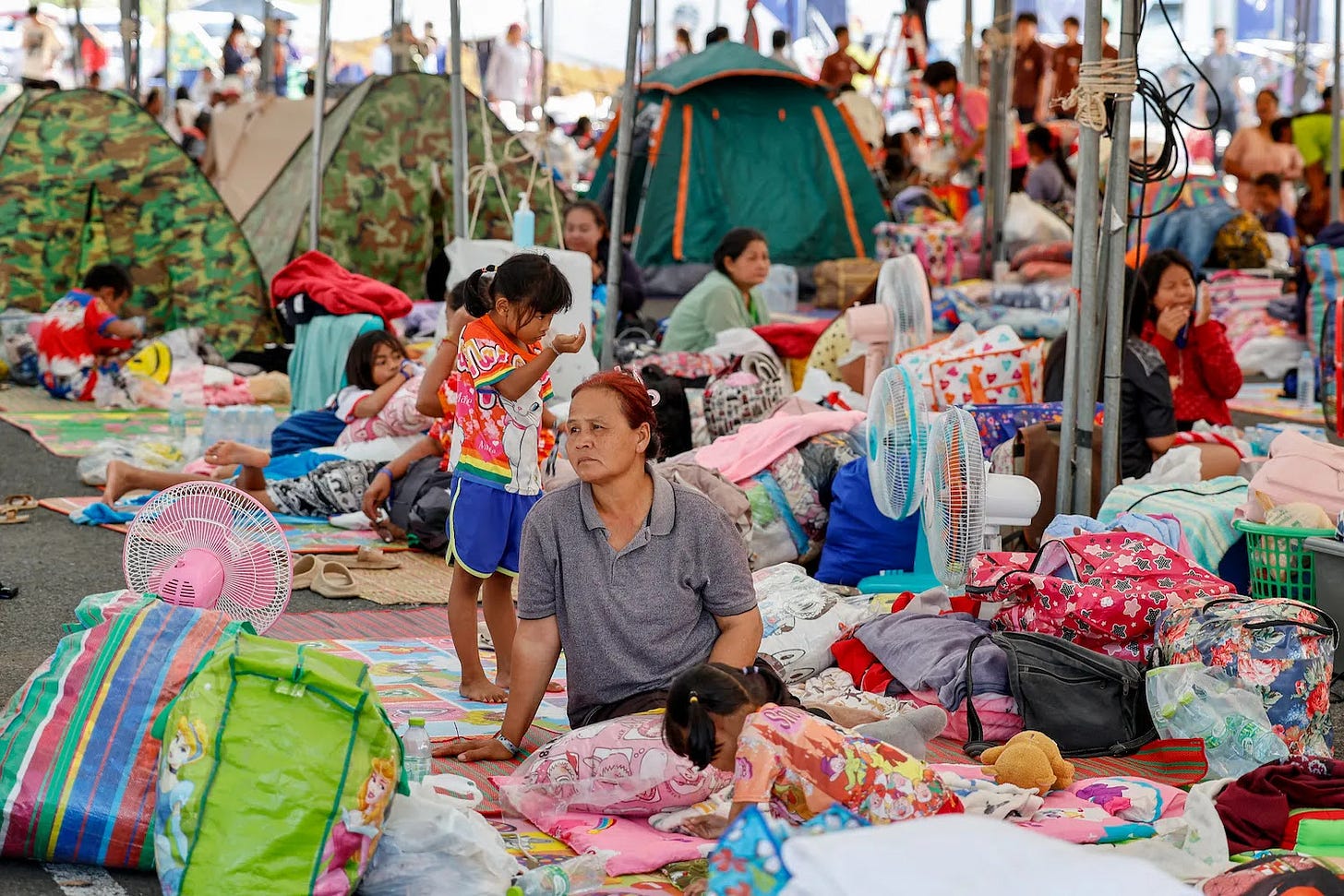 Evacuated Thai residents gather at a temporary shelter in Thailand.