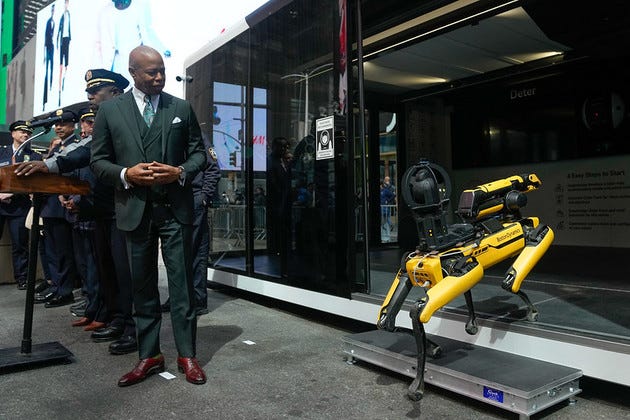 Eric Adams unveils a yellow and black version of the NYPD's new robotic police dog. Eric Adams unveils a yellow and black version of the NYPD's new robotic police dog.