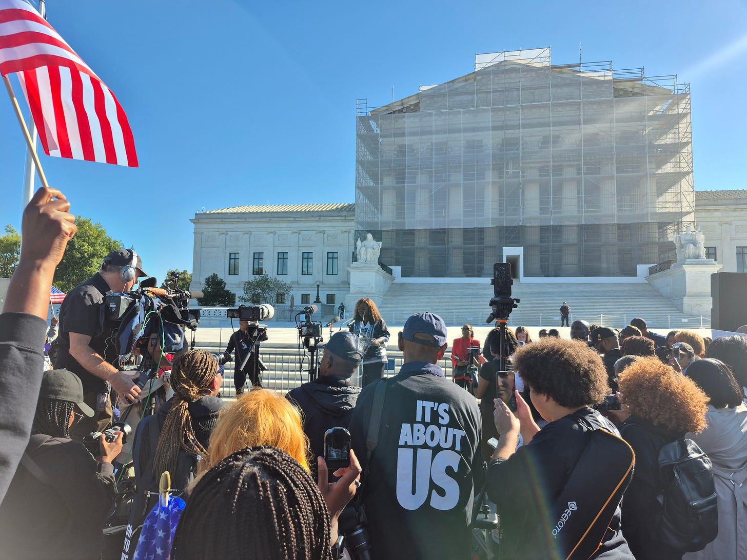 How to Fight Fascism in America: Economic Justice. image of rally in front of supreme court.