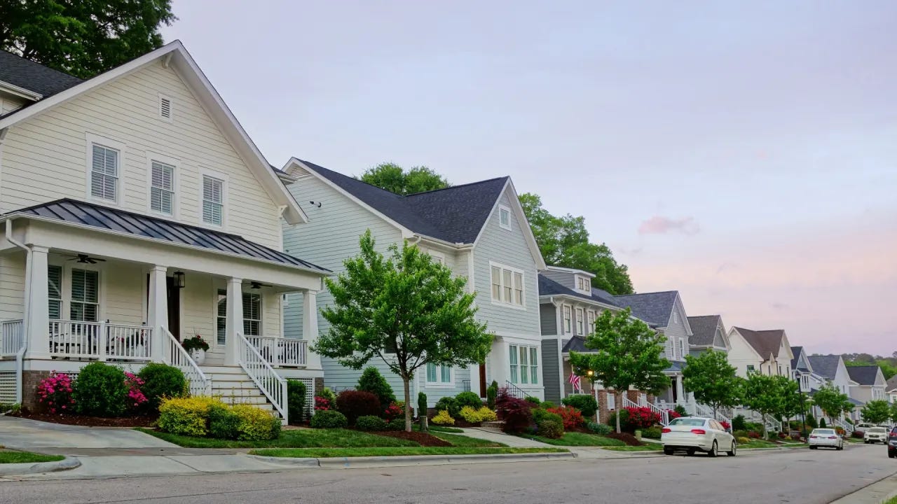 A row of houses on a street

Description automatically generated