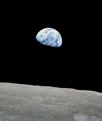The planet Earth rising above the horizon of the Moon