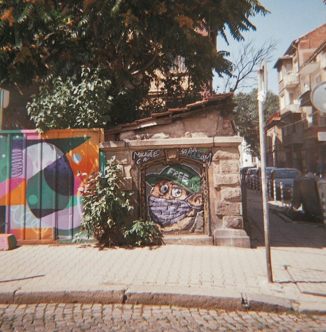 a building with a colorful gate on the side of it