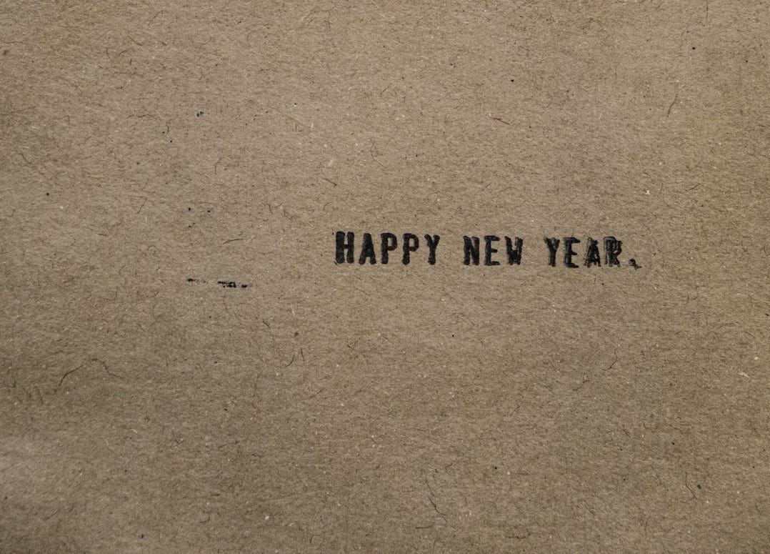 a piece of brown paper with the words happy new year written on it