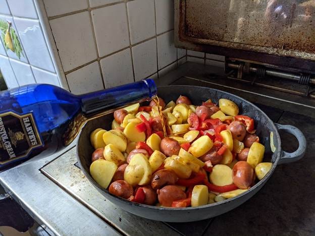 A bowl of potatoes and peppers being poured into a pan

AI-generated content may be incorrect.