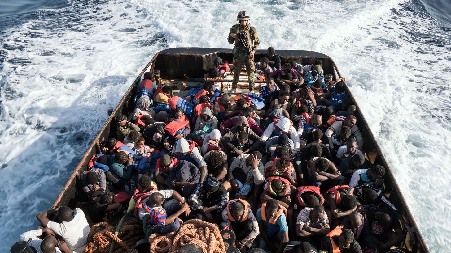 A member of the Libyan coast guard stands on a boat after picking up migrants off of the town of Zawiyah, 45 kilometres west of the capital Tripoli, in June 2017.