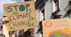 Photo of signs at a protest, saying "Stop Climate Change" and "Stop Global Warming"