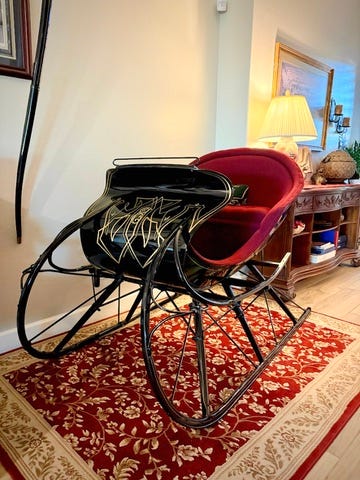 black Victorian sleigh on a red carpet