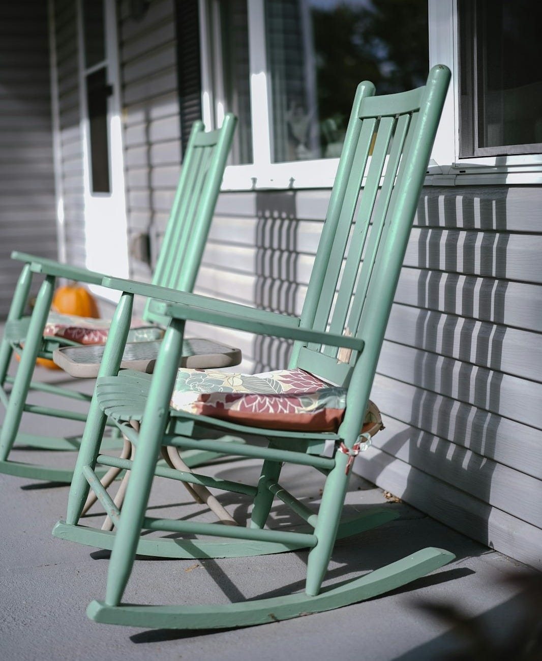 empty gray wooden rocking chairs