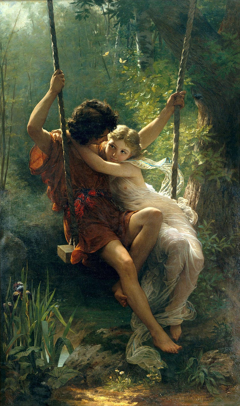 a young man and an young woman stare lovingly into each others' eyes while sitting on a swing in the forest