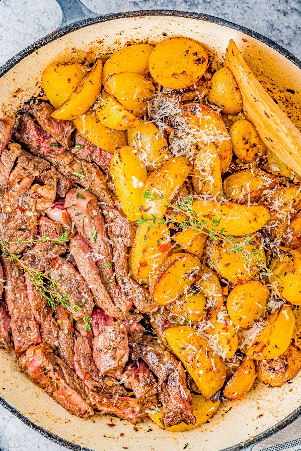 Steak and Potatoes Skillet topped with Parmesan. 
