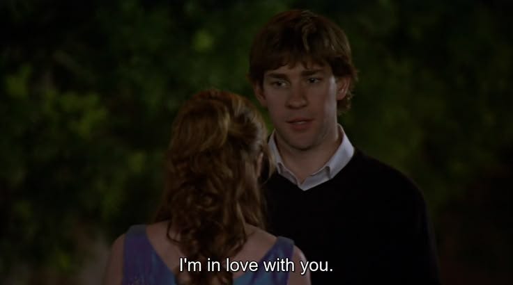 This may contain: a young man and woman standing next to each other with the words i'm in love with you