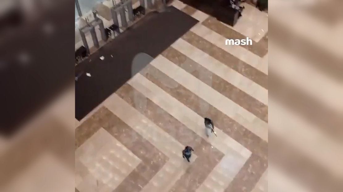 This screen grab from video shows armed men inside the Crocus City Hall concert venue in Moscow region, Russia. CNN can not verify whether these are the armed attackers or Russian authorities moving in.  
