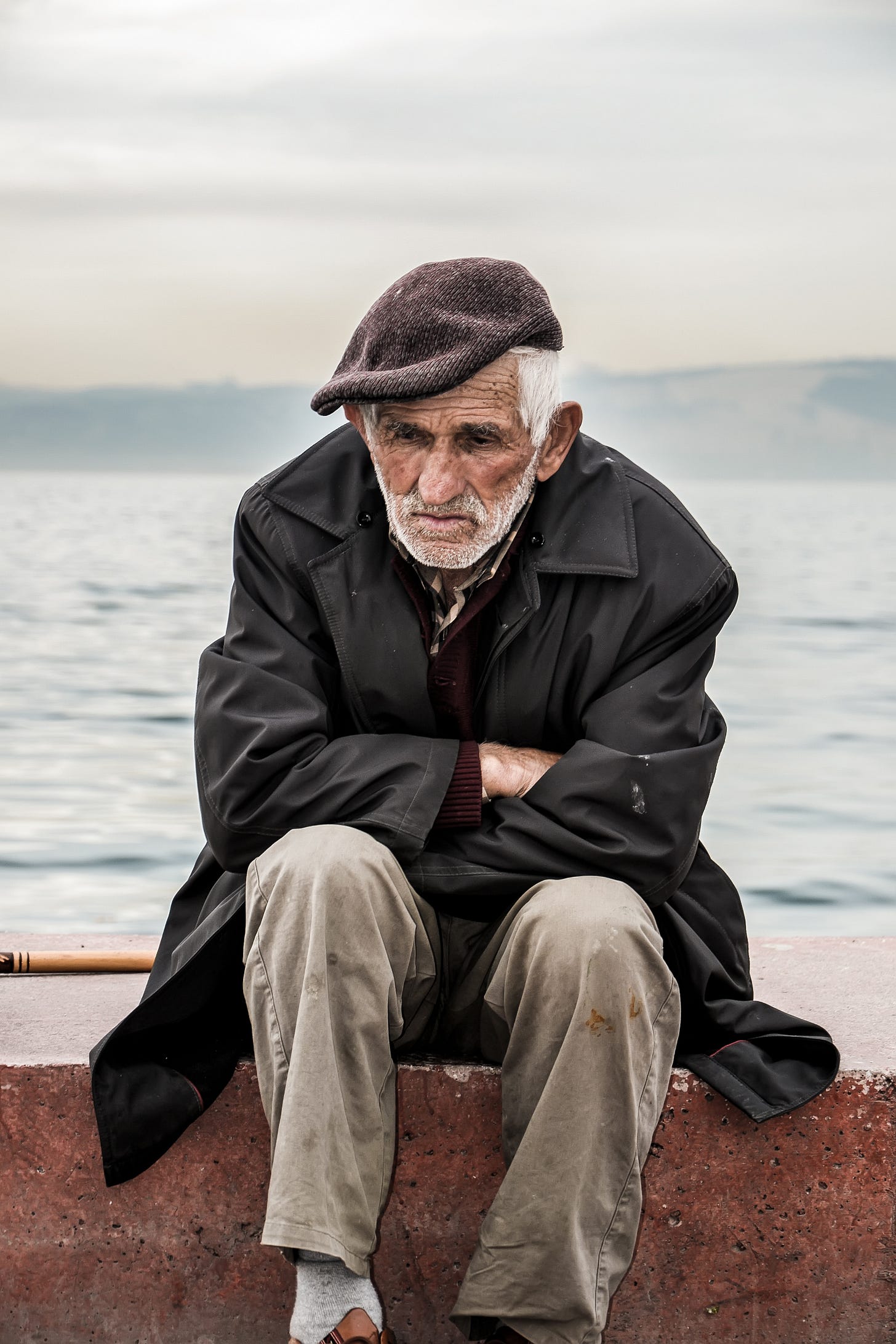 A lonely old man sitting on the beach waiting for somebody? A lonely old man sitting on the beach waiting for somebody?
