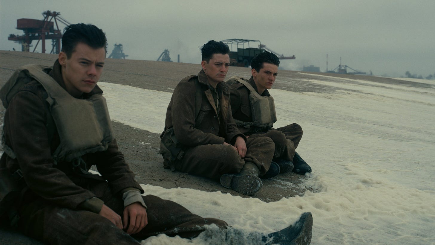 Dunkirk | Still features Harry Styles, Aneurin Barnard, and Fionn Whitehead as soldiers on Dunkirk beach.
