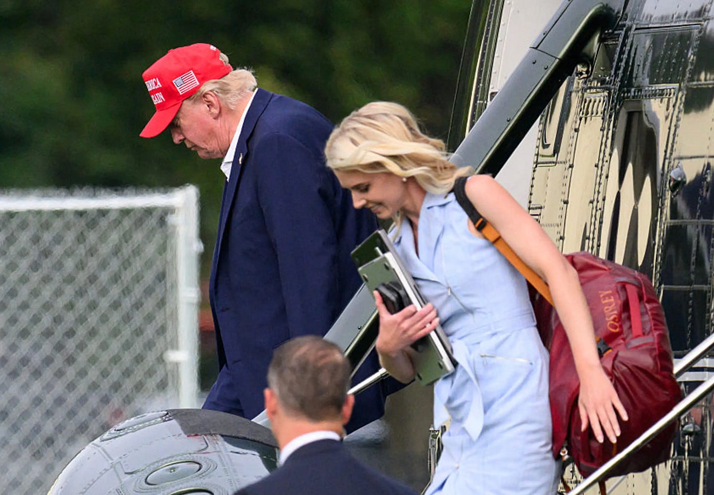 Donald Trump walking next to aide Natalie Harp