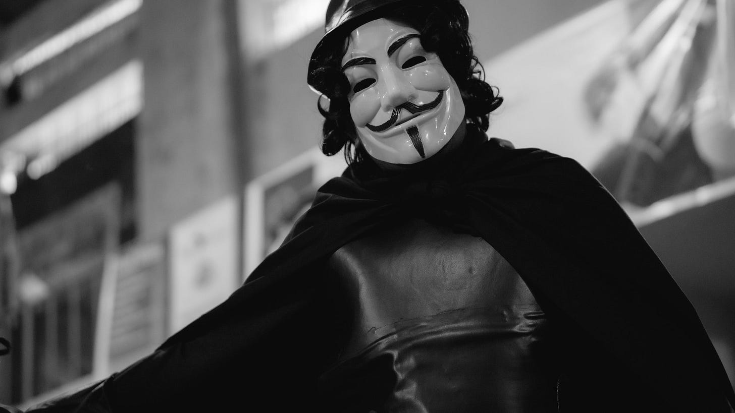 a man wearing a mask and cape a man wearing a mask and cape