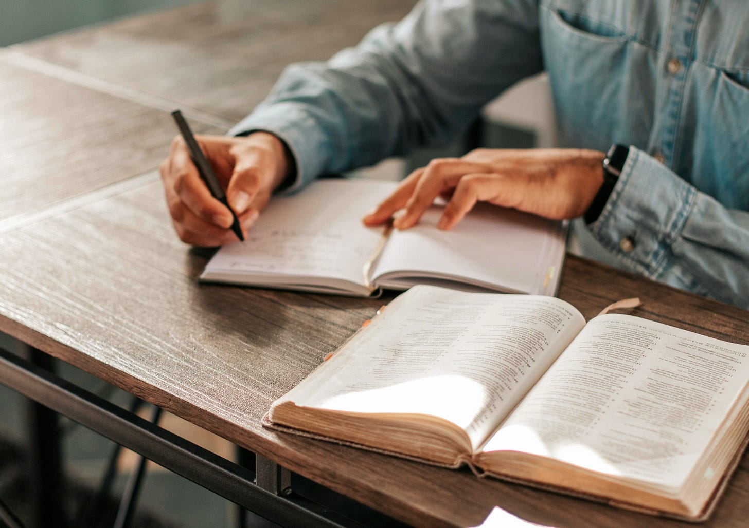 A person writing in a notebook