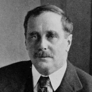 Black-and-white photograph of fantasy / sci-fi author H. G. Wells, who wrote the short story "The Magic Shop."