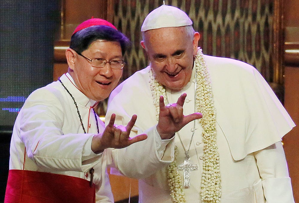 Cardinal Luis Antonio Tagle shows Pope Francis the “I love you” hand sign in Manila Cardinal Luis Antonio Tagle shows Pope Francis the “I love you” hand sign in Manila