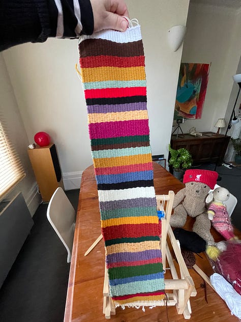loom in trash and then being used to weave a striped textile