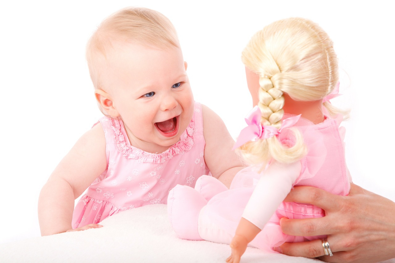 baby girl happy smile with baby doll holiday gifts