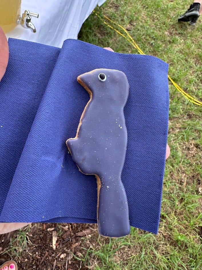 Cookies shaped and colored like purple martin birds. 
