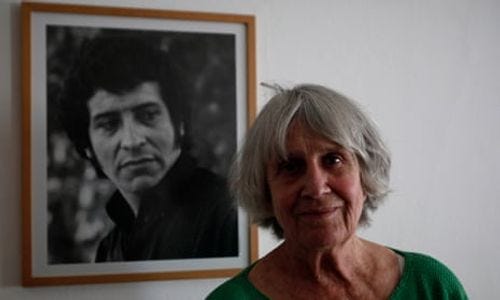 Joan Jara stands in front of a photograph of her husband, Victor, who was tortured and killed in 1973.