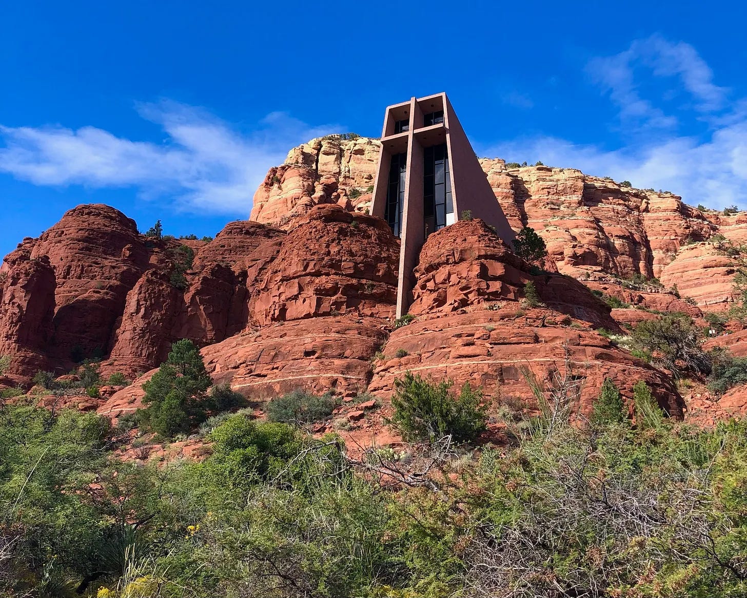 The Chapel of the Holy Cross built into Sedona's red rocks, showing the dramatic architecture and surrounding desert landscape