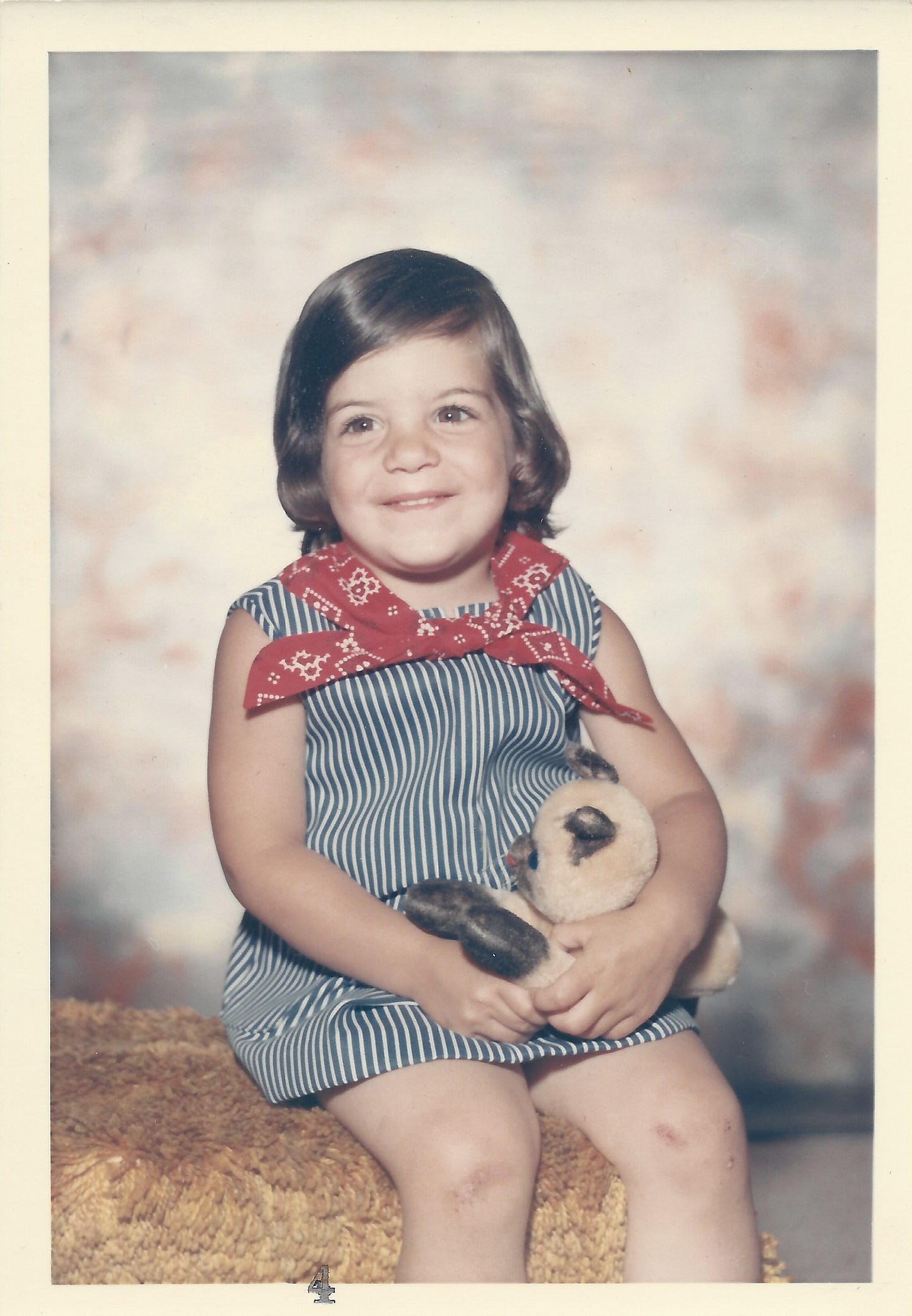 girl in striped dress posing for picture