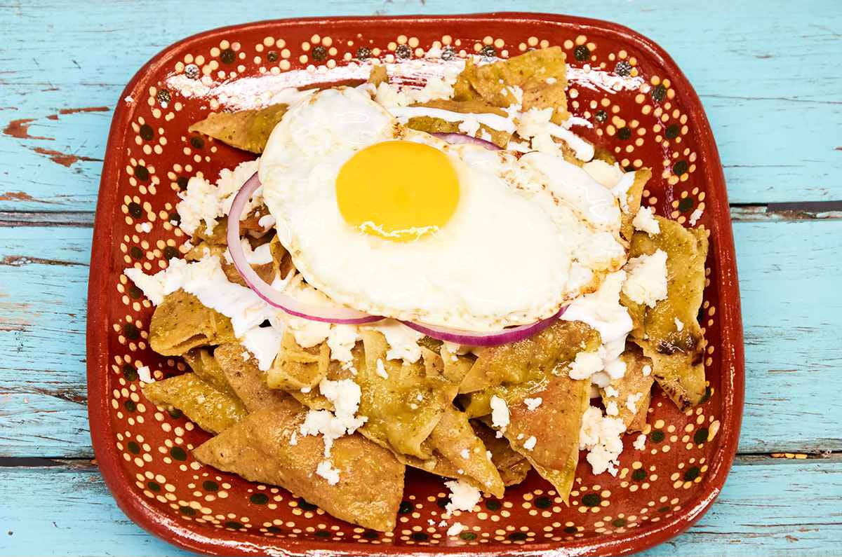 plate of chilaquiles verdes with a fried egg